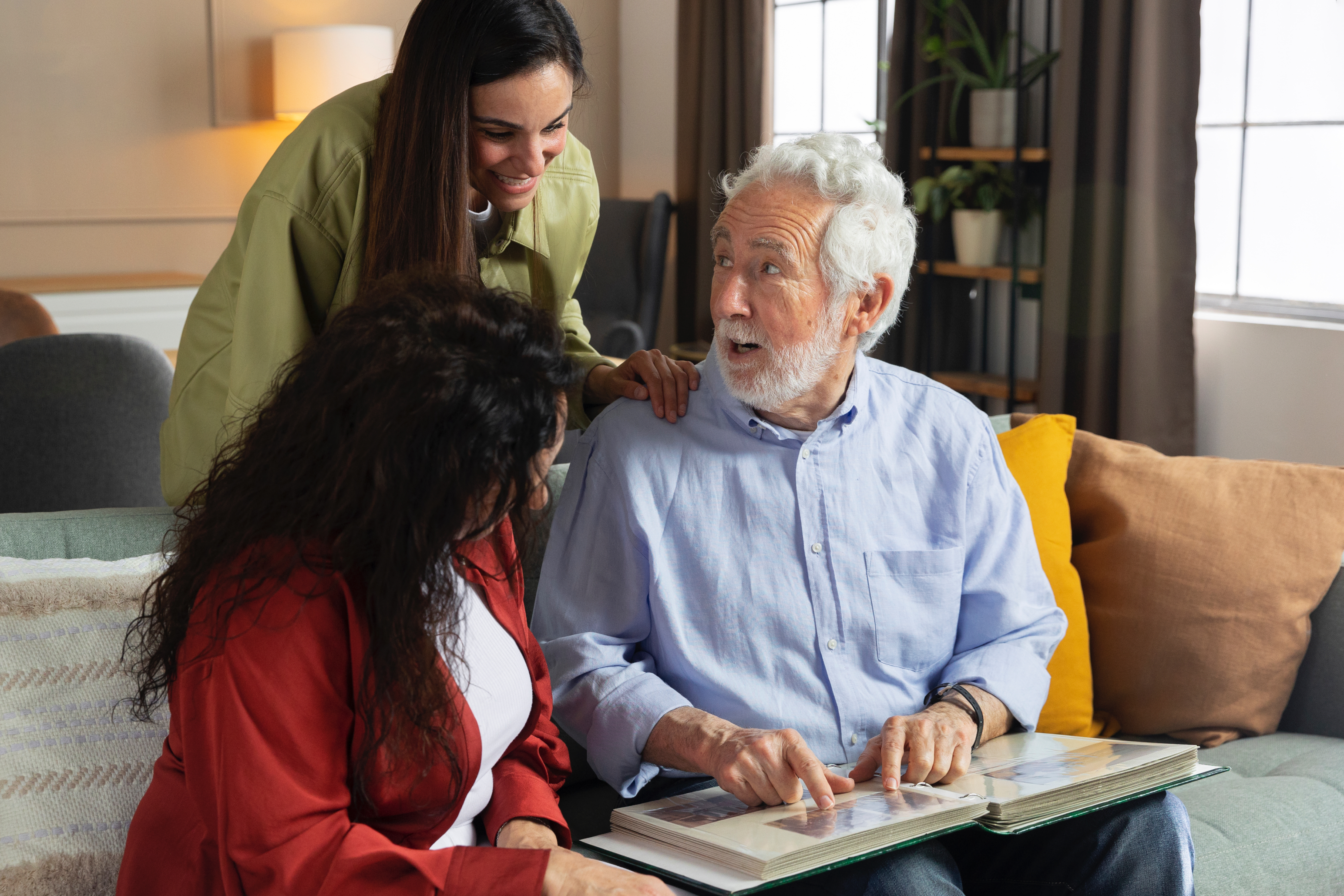 Family speaking with elderly man at home